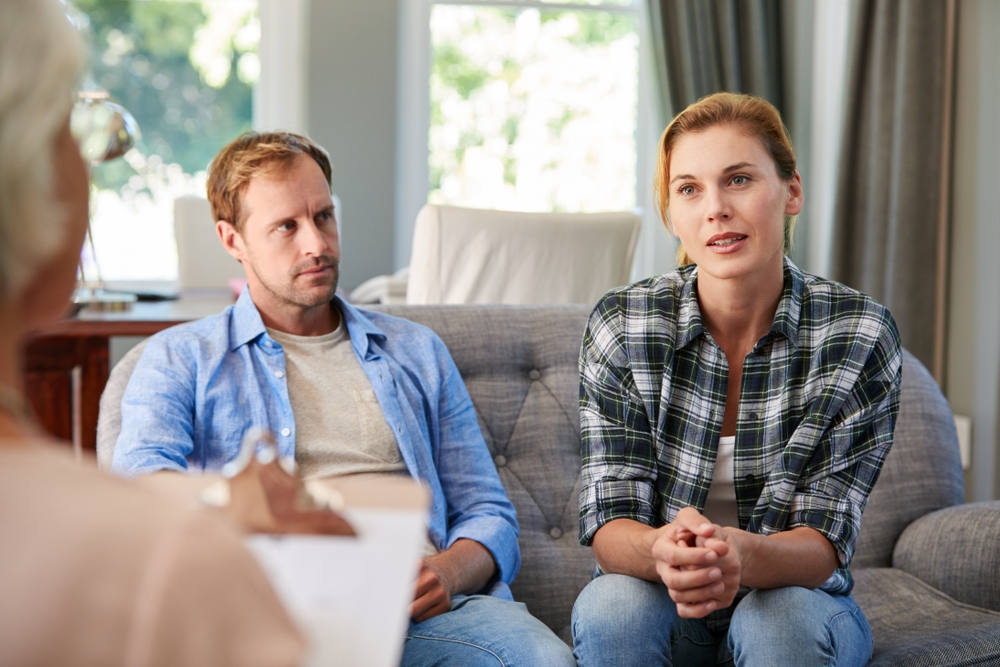 Couple speaking with their wealth manager regarding estate plan